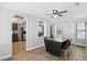 Open dining room featuring wood-look floors, modern ceiling fan, and views to the kitchen and entry door at 211 Agua Vista St, Debary, FL 32713
