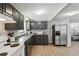 This open-concept kitchen features gray cabinets, tile floor, modern appliances, and lots of counter space at 211 Agua Vista St, Debary, FL 32713