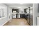 Bright kitchen features stainless appliances, gray cabinets, tile floor and backyard view from the window above the sink at 211 Agua Vista St, Debary, FL 32713