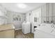 Bright laundry room with countertop, shelving, washer, and dryer hookups at 211 Agua Vista St, Debary, FL 32713