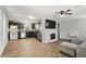 Open floorplan featuring wood-look floors, fireplace, easy access to the kitchen, and a cozy seating area at 211 Agua Vista St, Debary, FL 32713