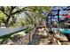 Well-maintained backyard with a white fence and lush greenery next to a screened-in pool area at 213 Almaden Ct, Winter Springs, FL 32708