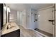 Bright bathroom featuring dual sinks, white subway tile shower, and black hardware at 213 Almaden Ct, Winter Springs, FL 32708