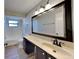 Bathroom featuring a dark vanity, a large mirror and a bathtub with shower at 213 Almaden Ct, Winter Springs, FL 32708