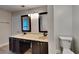 Bathroom features dual sinks, dark cabinets, neutral counters, and modern fixtures at 213 Almaden Ct, Winter Springs, FL 32708