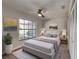 Cozy bedroom with a ceiling fan, large window with outdoor view, and neutral decor at 213 Almaden Ct, Winter Springs, FL 32708
