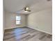 Bedroom featuring wood-look floors, neutral paint, and modern ceiling fan at 213 Almaden Ct, Winter Springs, FL 32708