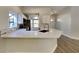 Modern kitchen with a breakfast bar featuring sleek quartz countertops and stainless steel appliances at 213 Almaden Ct, Winter Springs, FL 32708