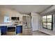 Kitchen featuring stainless steel appliances, including a refrigerator and electric range, with blue and white cabinets at 213 Almaden Ct, Winter Springs, FL 32708