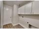 Functional laundry room with storage cabinets and convenient washer/dryer hookups at 213 Almaden Ct, Winter Springs, FL 32708