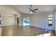 Open-concept living room with wood-look flooring and sliding glass doors overlooking the pool area at 213 Almaden Ct, Winter Springs, FL 32708