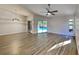 Bright living room with sleek wood-look floors, modern light fixture, and pool views at 213 Almaden Ct, Winter Springs, FL 32708