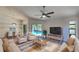 Inviting living room with comfortable seating, a ceiling fan, and a view of the pool area at 213 Almaden Ct, Winter Springs, FL 32708