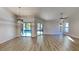 Spacious living room showcasing wood floors, a ceiling fan, and access to the pool area at 213 Almaden Ct, Winter Springs, FL 32708