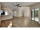 Open-concept living room featuring modern lighting, and stylish wood-look floors at 213 Almaden Ct, Winter Springs, FL 32708