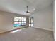 Main bedroom featuring a ceiling fan, window with a view of the pool, and neutral-colored carpet at 213 Almaden Ct, Winter Springs, FL 32708