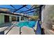 A refreshing pool with a screened enclosure, surrounded by a concrete patio and lush greenery at 213 Almaden Ct, Winter Springs, FL 32708
