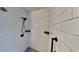 Modern shower with white subway tiles, black fixtures, and a gray tiled floor at 213 Almaden Ct, Winter Springs, FL 32708
