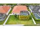 Aerial view of a home with a red tile roof, screened-in pool, and landscaped backyard at 2359 Baronsmede Ct, Winter Garden, FL 34787