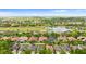 Expansive aerial view of a residential community featuring well-maintained homes, a golf course, and a scenic lake at 2359 Baronsmede Ct, Winter Garden, FL 34787