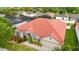 Aerial view of a single-story home with a red tile roof, garden, and attached garage at 2359 Baronsmede Ct, Winter Garden, FL 34787