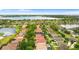 Aerial view of a residential neighborhood showcasing houses with pools and lush landscaping near a serene lake at 2359 Baronsmede Ct, Winter Garden, FL 34787