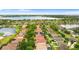 Aerial view of a residential neighborhood showcasing houses with pools and lush landscaping near a serene lake at 2359 Baronsmede Ct, Winter Garden, FL 34787