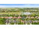 Expansive aerial view of a residential community featuring well-maintained homes, a golf course, and a scenic lake at 2359 Baronsmede Ct, Winter Garden, FL 34787