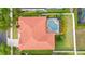 Aerial view showcases a red tile roof and backyard pool area with mature landscaping at 2359 Baronsmede Ct, Winter Garden, FL 34787