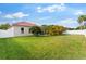 Expansive backyard with lush green grass, mature trees, and a putting green at 2359 Baronsmede Ct, Winter Garden, FL 34787