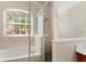 Bathroom with a shower stall and soaking tub near a large window at 2359 Baronsmede Ct, Winter Garden, FL 34787