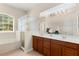 Bright bathroom with a double vanity, large mirror, separate shower stall and soaking tub at 2359 Baronsmede Ct, Winter Garden, FL 34787