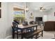 Inviting dining area featuring dark wood table and chairs, plus a view of the pool through a large window at 2359 Baronsmede Ct, Winter Garden, FL 34787