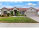 Well-maintained single-story home with a red tile roof, manicured landscaping, and a brick driveway at 2359 Baronsmede Ct, Winter Garden, FL 34787