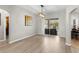 Open living area with wood floors, a large sliding glass door, and views of the screened-in lanai at 2359 Baronsmede Ct, Winter Garden, FL 34787