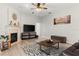 Inviting living room with fireplace, ceiling fan, modern decor, and plenty of natural light at 2359 Baronsmede Ct, Winter Garden, FL 34787