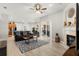 Open living room with fireplace, hardwood floors, and access to dining area and kitchen at 2359 Baronsmede Ct, Winter Garden, FL 34787