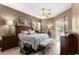 Tranquil main bedroom with king bed, hardwood floors, ceiling fan, and access to the lanai at 2359 Baronsmede Ct, Winter Garden, FL 34787