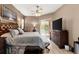 Cozy main bedroom with king size bed, ceiling fan, hardwood floors, and lanai access at 2359 Baronsmede Ct, Winter Garden, FL 34787