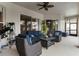 Covered patio with ceiling fan, outdoor seating, and sliding glass doors at 2359 Baronsmede Ct, Winter Garden, FL 34787