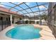 Beautiful pool with a screened enclosure, red tile roof and landscaping at 2359 Baronsmede Ct, Winter Garden, FL 34787