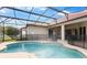 Screened-in pool with a red tile roof and a well manicured green lawn at 2359 Baronsmede Ct, Winter Garden, FL 34787