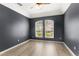 Comfortable room with neutral walls, light wood floors, and bright windows at 2359 Baronsmede Ct, Winter Garden, FL 34787