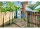 Backyard with wooden fence and mature trees, providing a secluded outdoor space at 2509 Formosa Ave, Orlando, FL 32804