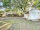 Spacious backyard with mature trees and a detached garage, perfect for outdoor activities at 2509 Formosa Ave, Orlando, FL 32804