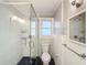 Bathroom featuring a glass shower, toilet, and white beadboard walls at 2509 Formosa Ave, Orlando, FL 32804