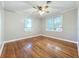 Spacious bedroom featuring gleaming hardwood floors, a ceiling fan, and natural light at 2509 Formosa Ave, Orlando, FL 32804