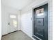 Hallway with two doors, light tile flooring, and neutral colored walls at 2509 Formosa Ave, Orlando, FL 32804