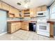 This kitchen features wood cabinets, tile floors and backsplash, and modern appliances at 2509 Formosa Ave, Orlando, FL 32804