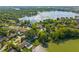 Overhead view of homes nestled among lush trees along a lake with private docks at 2922 Carmia Dr, Orlando, FL 32806